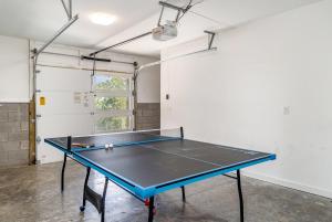 a ping pong table in the middle of a room at Double Time - Ping-Pong Table - Mins to Germantown in Nashville