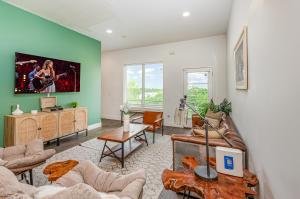a living room with a couch and a table at Double Time - Ping-Pong Table - Mins to Germantown in Nashville