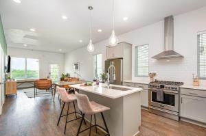a kitchen with a island and chairs in it at Double Time - Ping-Pong Table - Mins to Germantown in Nashville