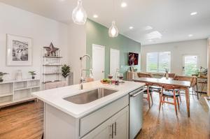 a kitchen with a sink and a dining room at Double Time - Ping-Pong Table - Mins to Germantown in Nashville