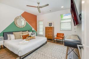 a bedroom with a large bed and a chair at Double Time - Ping-Pong Table - Mins to Germantown in Nashville