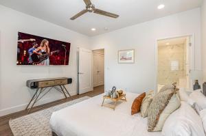 a bedroom with a bed with a guitar on the wall at Double Time - Ping-Pong Table - Mins to Germantown in Nashville
