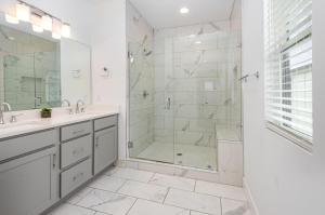 a white bathroom with a shower and a sink at Double Time - Ping-Pong Table - Mins to Germantown in Nashville