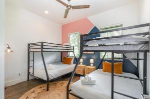 two bunk beds in a room with a ceiling at Double Time - Ping-Pong Table - Mins to Germantown in Nashville