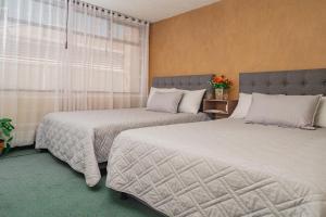 Postel nebo postele na pokoji v ubytování Innovar Casa Hostal