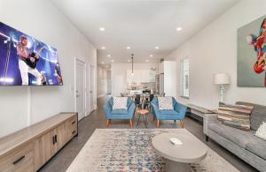 a living room with a couch and a table at Double Time - Ping-Pong Table - Mins to Germantown in Nashville