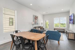 a living room with a table and chairs at Double Time - Ping-Pong Table - Mins to Germantown in Nashville