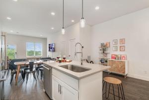 a kitchen with a sink and a table with chairs at Double Time - Ping-Pong Table - Mins to Germantown in Nashville