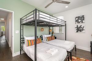 two bunk beds in a room with a hallway at Double Time - Ping-Pong Table - Mins to Germantown in Nashville +37 photos