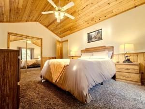 a bedroom with a bed and a ceiling fan at 3BR Home w Game Room by The Village, Lake & Summit in Big Bear Lake