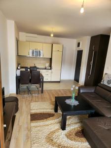 a living room with a couch and a table at Omega 2 Apartment Budva in Budva +8 photos