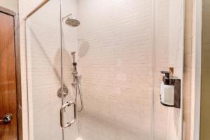 a shower with a glass door in a bathroom at Self Check-In Boutique Hotel - Quartier latin - Room 101 in Montréal +13 photos