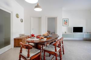 a dining room with a table and chairs and a television at GuestHost - Oasi Monticelli in Polignano a Mare