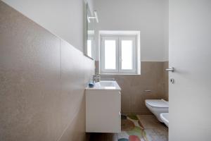 a bathroom with a sink and a toilet at GuestHost - Oasi Monticelli in Polignano a Mare +27 photos