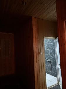 an empty room with a window in a house at Bata GuesThouse in Adishi