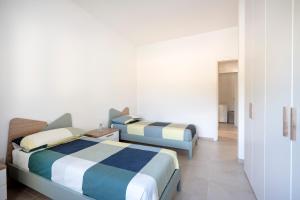 a bedroom with two beds in a room at GuestHost - Oasi Monticelli in Polignano a Mare