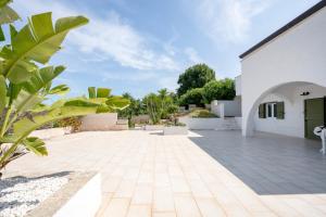a courtyard of a house with a patio at GuestHost - Oasi Monticelli in Polignano a Mare