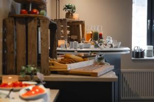 a kitchen counter with a bunch of food on it at Villa Gutebagge Hotell in Visby