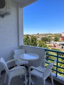 a table and chairs on a balcony with a view at Xh&S Apartament in Durrës