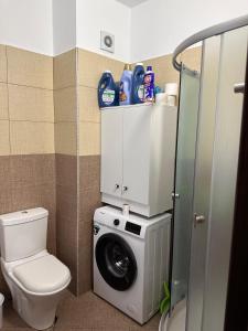 a bathroom with a washing machine and a toilet at Xh&S Apartament in Durrës +4 photos