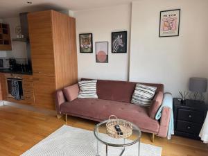 a living room with a couch and a glass table at Luxury Cove at the Docks in Leeds