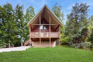 a house with a wrap around deck on a lawn at Awesome View in Henderson Springs