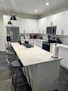 a kitchen with white cabinets and a white counter top at Tampa Lounge in Ybor in Tampa
