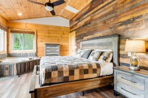 a bedroom with a bed and a tub in a room at Waynesville Romantic Hideaway with Private Hot Tub in Waynesville