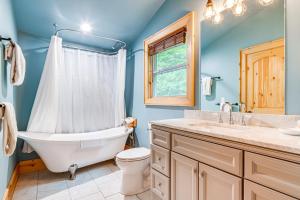 a bathroom with a tub and a toilet and a sink at Waynesville Romantic Hideaway with Private Hot Tub in Waynesville +24 photos