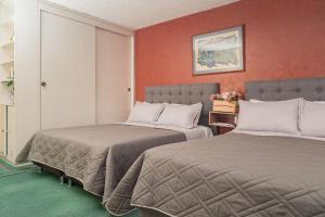 Postel nebo postele na pokoji v ubytování Innovar Casa Hostal