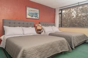 Postel nebo postele na pokoji v ubytování Innovar Casa Hostal