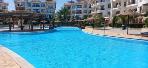 a swimming pool with a bridge and some buildings at Sharm hills sea view in Sharm El Sheikh