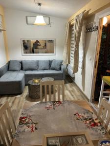 a living room with a couch and a table at Kuća za odmor in Đenovići
