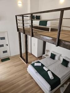 a bedroom with two bunk beds in a room at Studio Piata Mare Mardomi in Sibiu