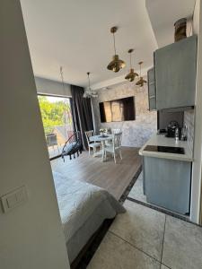a kitchen and a living room with a table at Cozy Apartment in Vilnius Paupys in Vilnius