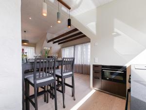 a kitchen with a bar with two chairs and a stove at Liblika Apartment in Tallinn