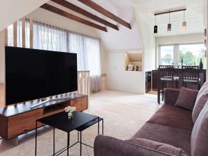 a living room with a large flat screen tv at Liblika Apartment in Tallinn