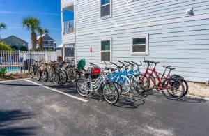 a group of bikes parked next to a building at Beachside Villas 122- Sun for the Roses in Santa Rosa Beach