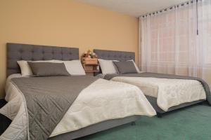 Postel nebo postele na pokoji v ubytování Innovar Casa Hostal