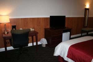 a hotel room with a bed and a television at Hotel North in North Sydney