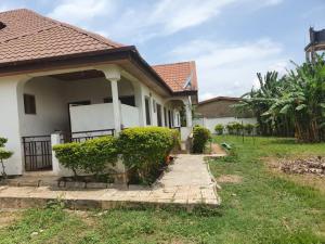 a house with a walkway leading into a yard at Adunni Court in Ilesa