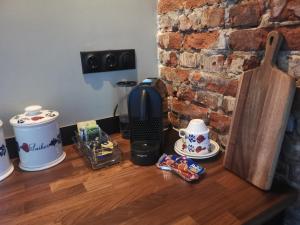 a desk with a coffee maker and cups on it at Farmstay Zijperdijk in Anna Paulowna
