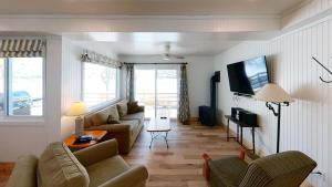 a living room with a couch and a tv at Elmhirst's Resort in Keene