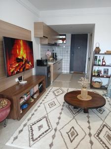 a living room with a tv and a table at Peache house in Ruaka