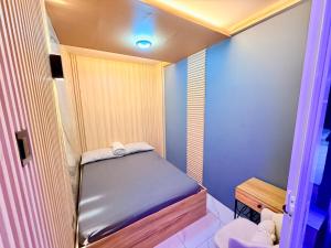 a small room with a small bed in it at 3BR Across Burnham Park Baguio Transient - Unit 23 in Baguio