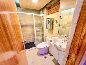 a bathroom with a toilet and a sink at 3BR Across Burnham Park Baguio Transient - Unit 23 in Baguio +38 photos