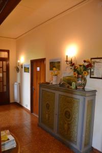 a room with a cabinet with flowers on top of it at Affittacamere La Fornace in Rigomagno