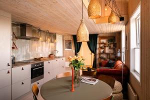 a kitchen with a table with a vase of flowers on it at VillaView Cabin in Oslo