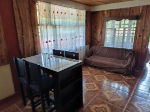 a living room with a table and a couch at Katty Mountain View in Concepción