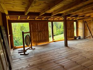 an empty room with a fan on a wooden floor at Estate Ana in Ptuj